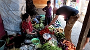 Manuel buys vegetables at the market in Antiqua.